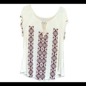 Cute ivory with black and red embroidery.